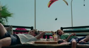 aftersun cinematography by gregory oke exterior day wide shot two shot hard light sunlight shot 052