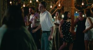 aftersun cinematography by gregory oke exterior night medium close up three shot silhouette artificial light shot 064