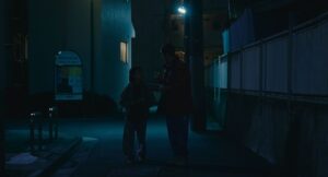 shoplifters cinematography by ry to kond night medium wide shot two shot artificial light shot 015