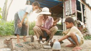 the act of killing cinematography by lars skree day medium close up three shot side lighting sunny shot 064